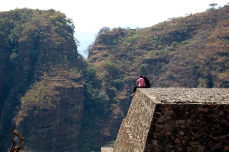 A couple enjoys the view from one of the ancient pyramids perched above town.